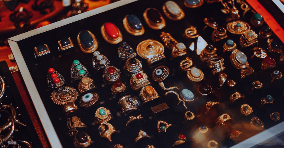 Showcase of vintage jewelry with ornate designs in a glass display case.